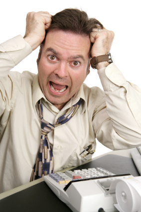 A man going crazy trying to do his own taxes. Isolated on white.